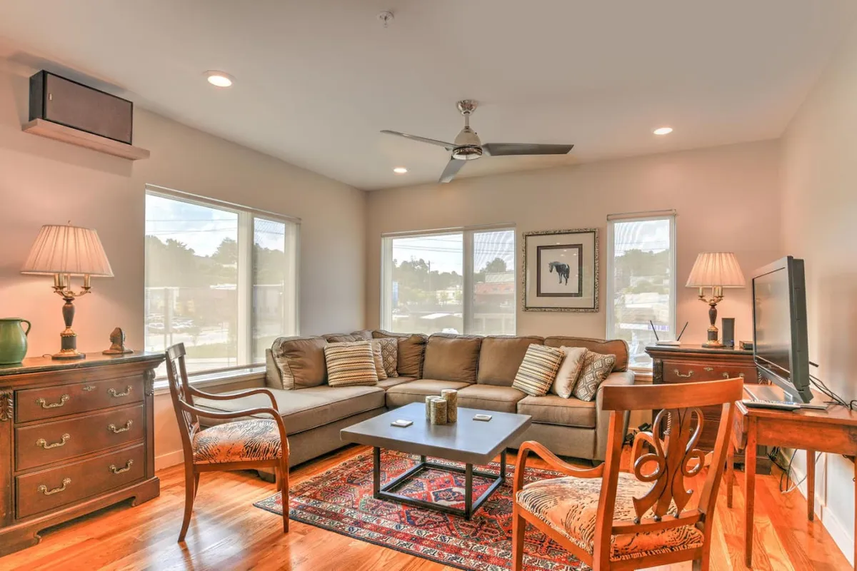 A comfortable living area is shown with a sofa, coffee table, and lamps, arranged for both relaxation and socializing. While not explicitly an entry, the layout hints at the flow from entry into the main living spaces, emphasizing the seamless transition and comfort of multi-level living.